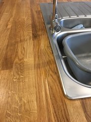 solid oak wood worktop restoration after having removed black mould and tannic acid stains from water damage. Black ring marks and stains removed after restoration!